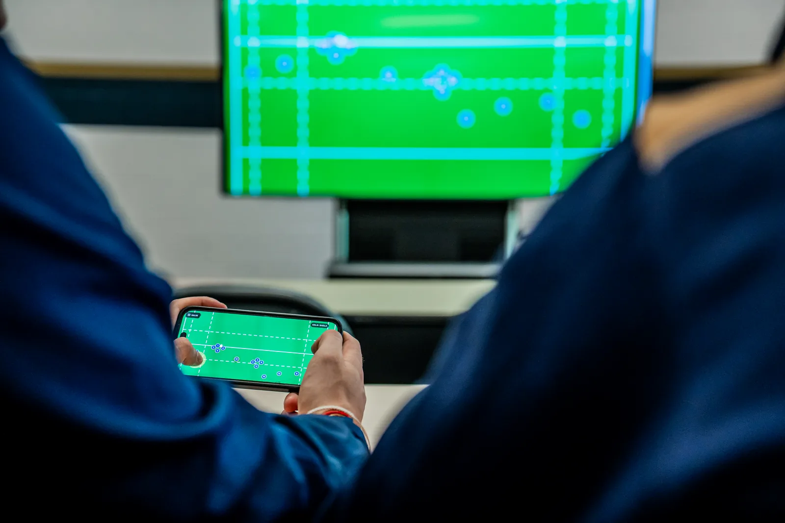 Player using Smart Gamepad on a phone during live practice
